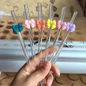 Detailed view of colorful glass straws with cute silicone bows in six various colors