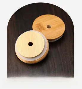 Detail of 700ml glass cup bamboo lids with silicone seal and straw hole macro view