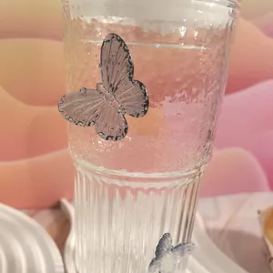 Macro detail of high-capacity glass cup featuring unique bubble texture and butterfly decor