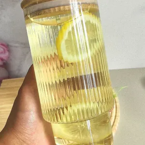Detail of 700ml vertical ribbed glass cup with bamboo lid and fresh lemon slices