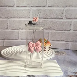 Detail view of square glass cup with pink 3D ribbon bow and matching straw decoration