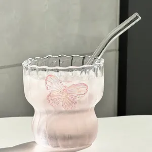 Elegant glass coffee cup with butterfly detail, wavy rim and glass straw for cold drinks