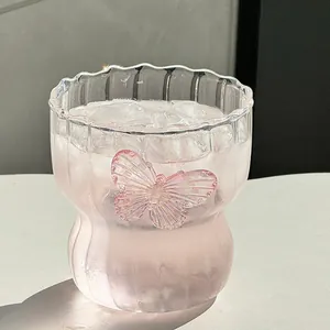 Elegant wavy glass coffee cup with pink 3D butterfly decoration and cinched waist