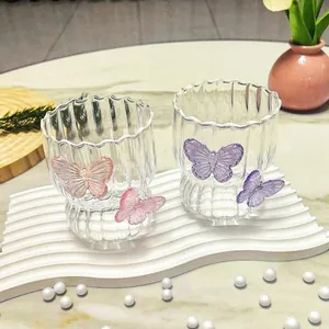 Detail of creative glass cups with 3D butterflies and elegant striped texture patterns