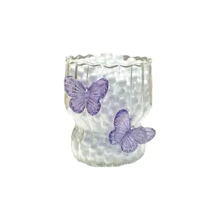 Textured butterfly glass cup with vertical ridges and elegant scalloped rim detail