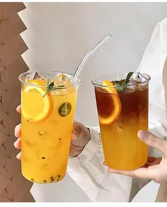 Detailed close-up of a high borosilicate glass cup with fresh fruit tea and a glass straw