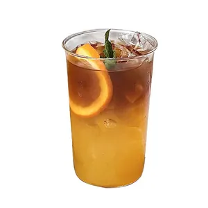 Minimalist high borosilicate glass coffee cup with layered cold fruit tea and fresh orange