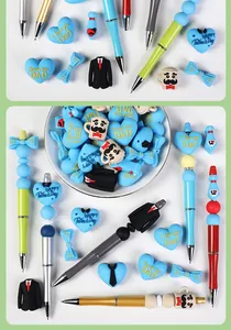 Close-up of Father's Day silicone beads with I Love You Dad text and themed charms