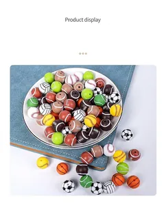 Close-up of 15mm sports-themed silicone beads for DIY necklaces featuring soccer and basketball