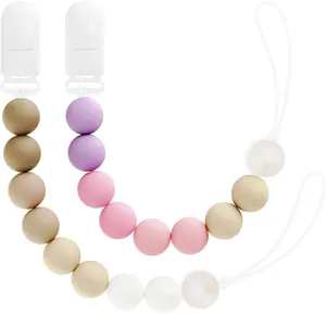 Dettaglio di due catenelle per ciuccio in silicone con perle sfumate e chiusure di sicurezza