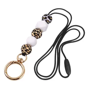 Detail of retractable silicone beaded lanyard with leopard print beads and gold clasp