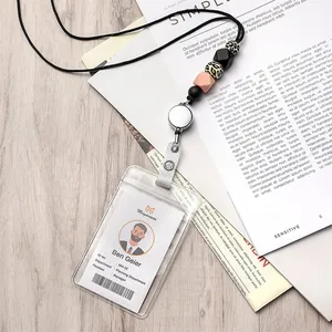 Macro view of retractable silicone beaded lanyard with card holder on wood desk