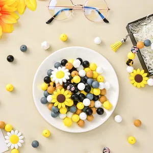 Flat lay of colorful silicone sunflower beads and round accessories for DIY jewelry making