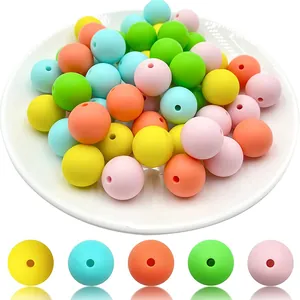 Close-up of matte colorful silicone beads in a white bowl for DIY jewelry making