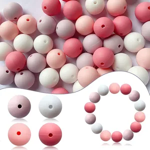 Macro detail of mixed matte silicone beads in pink and white tones for DIY jewelry making