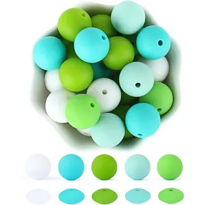 Colorful silicone beads set in a white bowl for DIY baby teething jewelry crafts