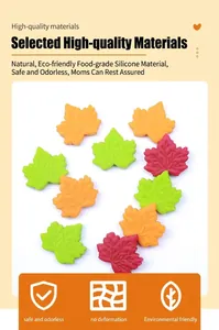 Detail of maple leaf silicone teething beads in green, orange, and red with vein texture