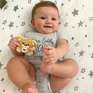Cartoon bear silicone baby teether in mustard yellow with grey star patterned cotton romper