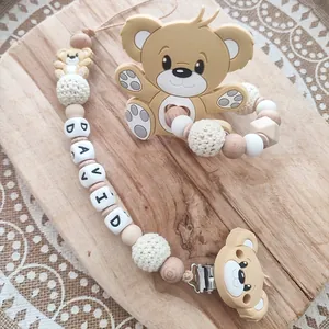 Detail of food-grade silicone baby teether pacifier clip with cartoon bear and wood beads