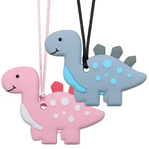 Detail of food-grade silicone dinosaur teethers in pink and blue-grey with soft textures