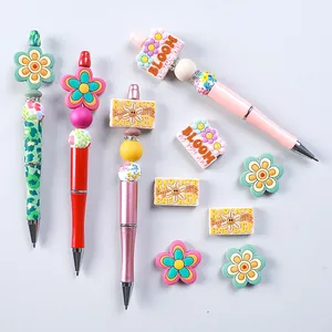 DIY silicone bead pen set with floral patterns and motivational quote charms for kids