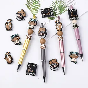DIY beadable pen set with cute cow and cowboy themed silicone beads and metallic pens