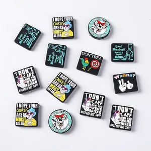 Flat lay macro of humorous silicone shoe charms with unicorns and funny text phrases
