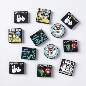Flat lay of PVC shoe charms featuring funny slogans and cartoon animal characters