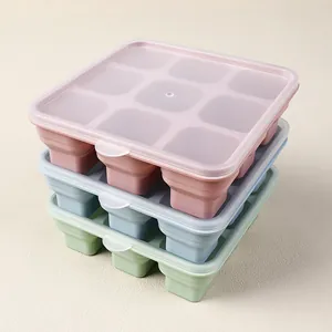 Stackable silicone ice cube trays with lids in pink, blue, and green for easy storage
