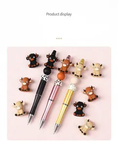 Detailed view of DIY bead pens featuring cute 3D silicone highland cow charms and beads