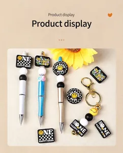 Detail of beaded pens and keychain with smiley face silicone beads and positive slogans