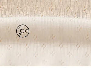 Detailed macro view of beige hollow diamond knit fabric showing soft texture and breathability