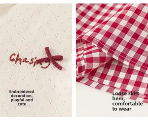 Detail of strawberry embroidery on knit bodice and red gingham plaid cotton skirt