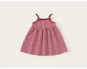 Detailed view of red gingham baby girl dress with cute strawberry appliques and pleated hem