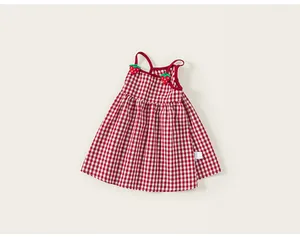 Detail of red gingham baby girl dress with cute 3D strawberry accents on the straps