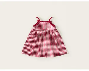 Detail of red gingham baby girl sundress showing delicate straps and pleated waist