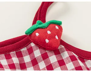 Close-up of girls' red gingham dress featuring a 3D embroidered strawberry detail