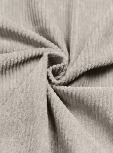 Macro shot of light gray corduroy fabric showing soft ribbed texture and premium weaving