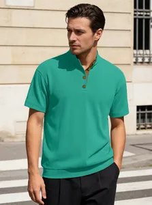Detail of turquoise knit polo shirt showing stand collar and textured corduroy fabric