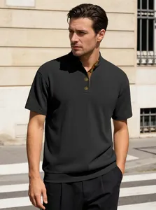 Detail of black ribbed knit polo with stand collar and contrasting brown inner lining