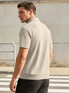 Detail showing beige short sleeve polo with vertical rib-knit texture and soft fabric