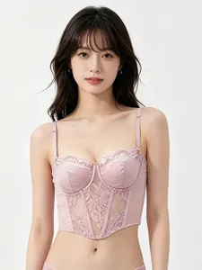 Close-up of pink satin and lace corset bra with delicate floral embroidery details
