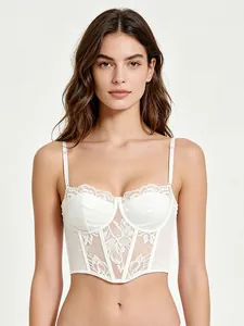Detail of white lace corset top featuring satin panels and structured boning design