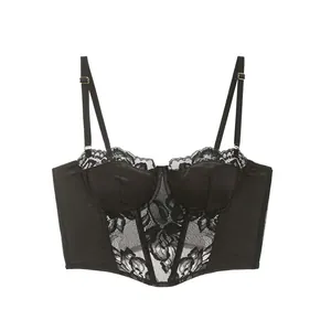Macro detail of black floral lace fabric and vertical boning on a corset bustier top