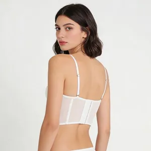 Back view of a white lace mesh bustier top with adjustable straps and hook closure