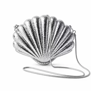 Elegant silver shell-shaped evening clutch bag with hammered texture and chain strap