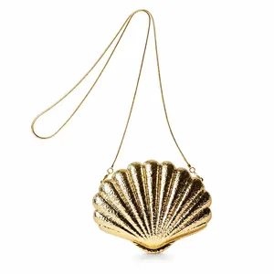 Elegant gold shell-shaped evening bag with hammer-textured metal and delicate chain strap