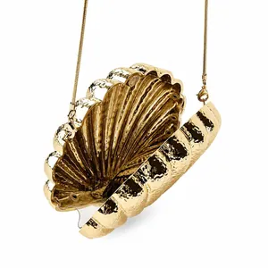 Elegant gold shell evening clutch bag with chain strap and polished metallic finish