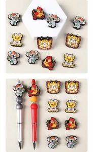 Detail of cute animal silicone beads on DIY beaded pens featuring bird and bear designs