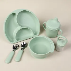 Detail view of a 6-piece sage green silicone baby feeding set with suction bowl and plate